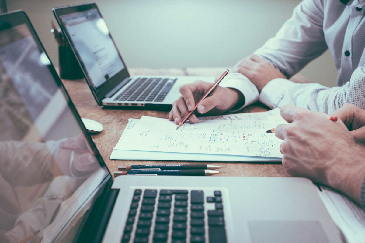 Schreibtisch mit Notizen und Laptop für Finanzrecherche